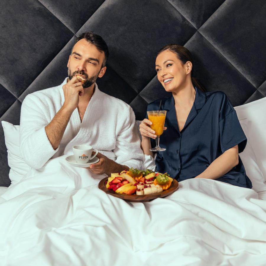 Hotel Pupin Novi Sad Bagian luar foto A couple having breakfast in bed